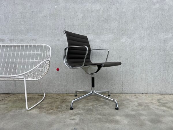 VITRA EAMES EA104 LEDEREN STOEL – MET LEDER OMMEZIJDE – SHOWROOMMODEL